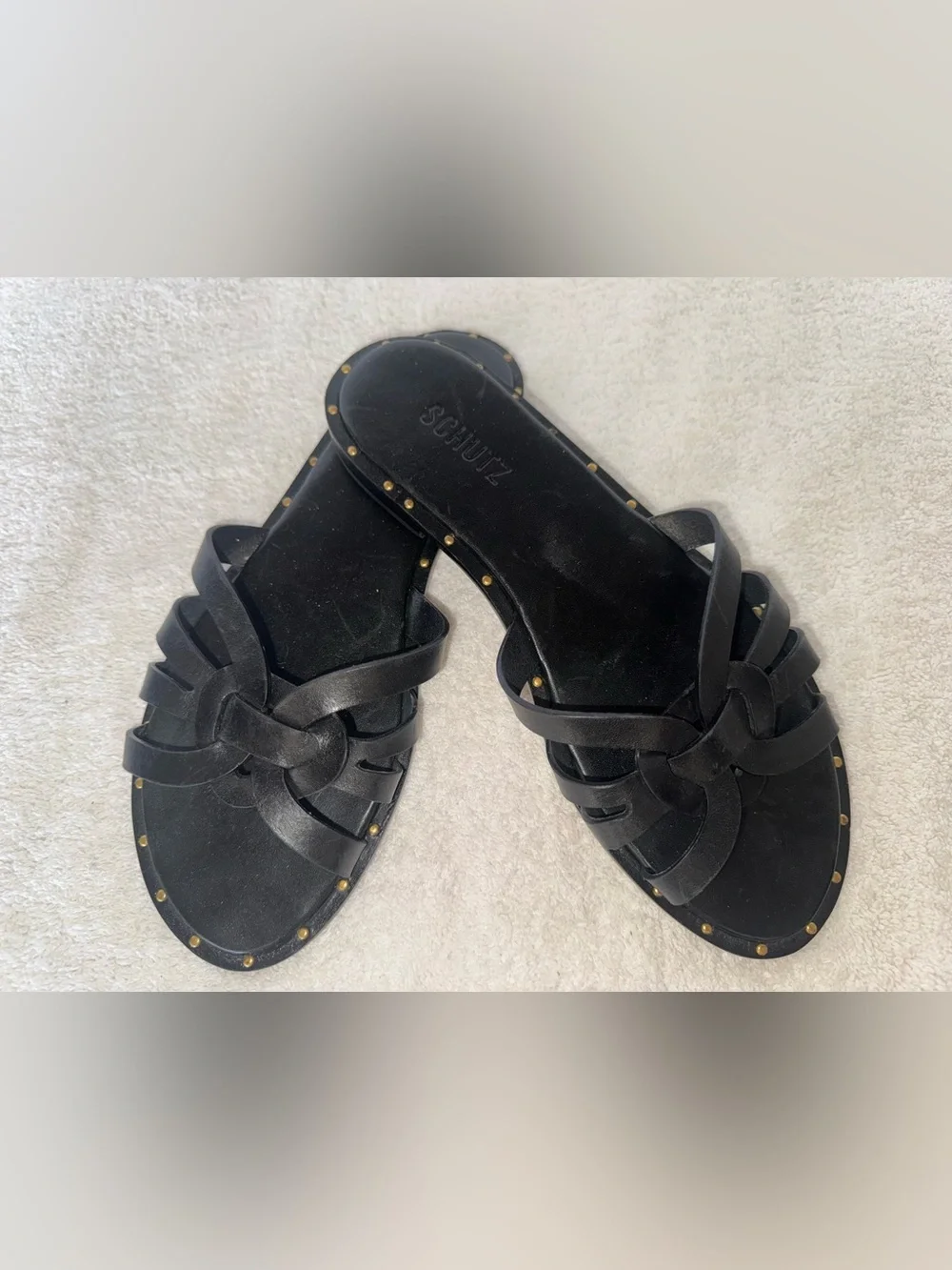 Schutz Phoenix flat sandals delicate woven straps n metallic stud along midsole.